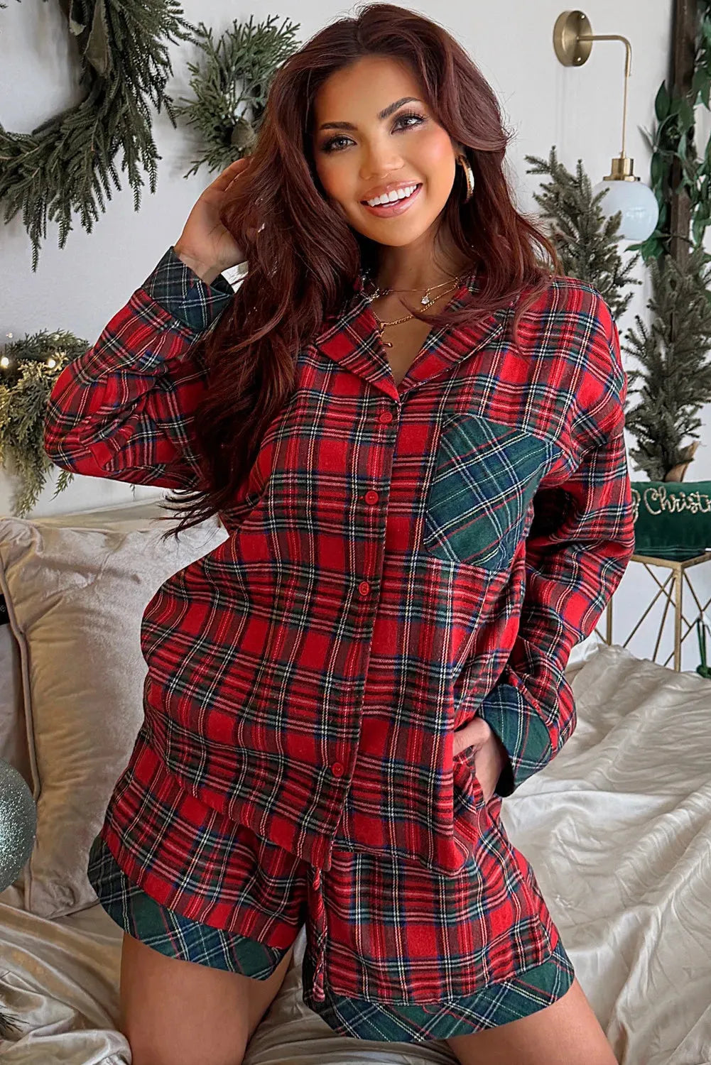 Red plaid Christmas pyjama set with contrasting fabric patches on shirt and shorts.
