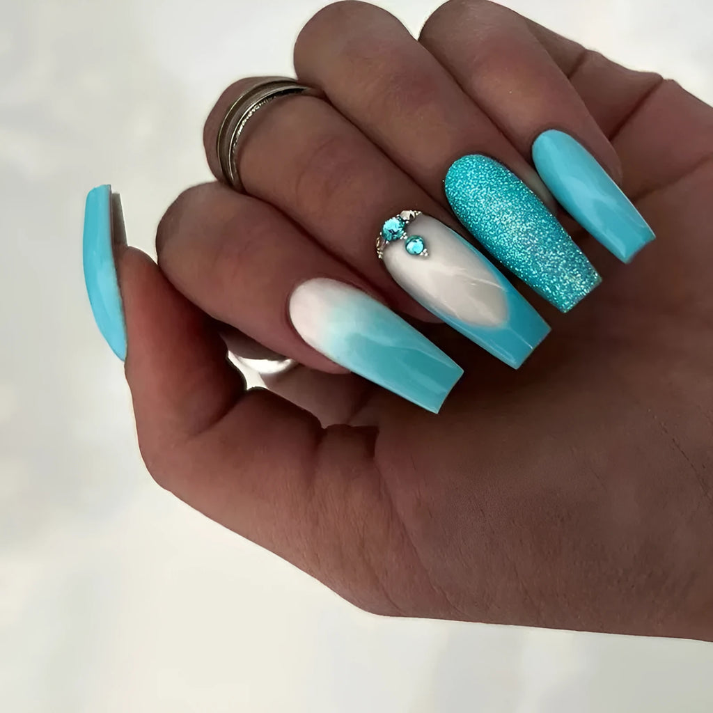 Long ballet-shaped false nail art patches in solid smart blue diamond colour with a tube of nail glue.