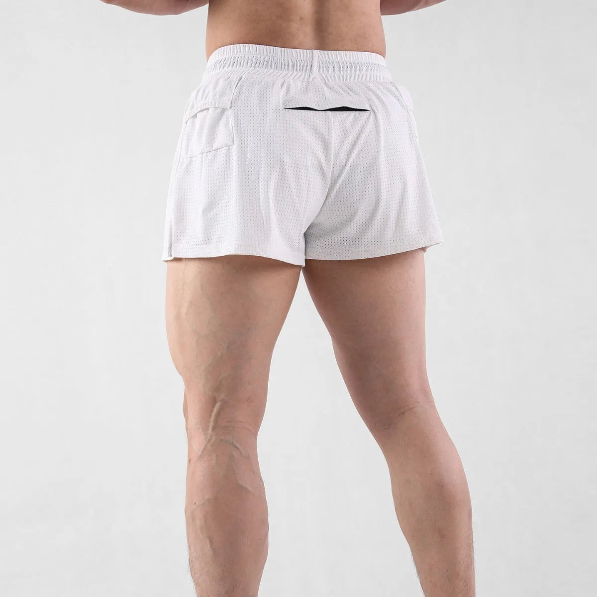 A pair of men's nylon summer shorts in black, showing the mid-waist design and short length for sports.