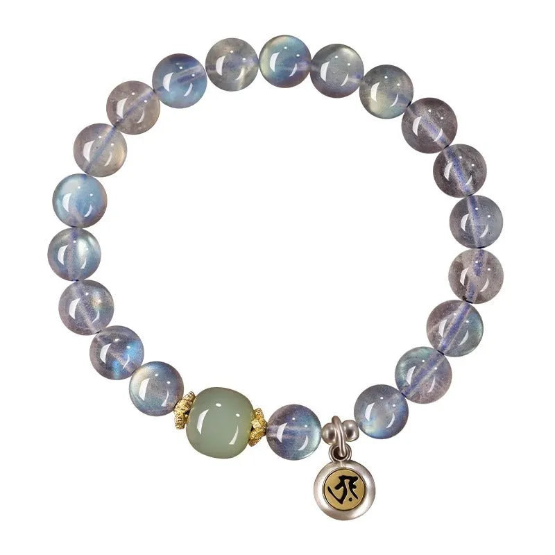 Close-up of a women's bracelet with 8mm moonstone beads and an electroplated Kwan-yin mouse charm.