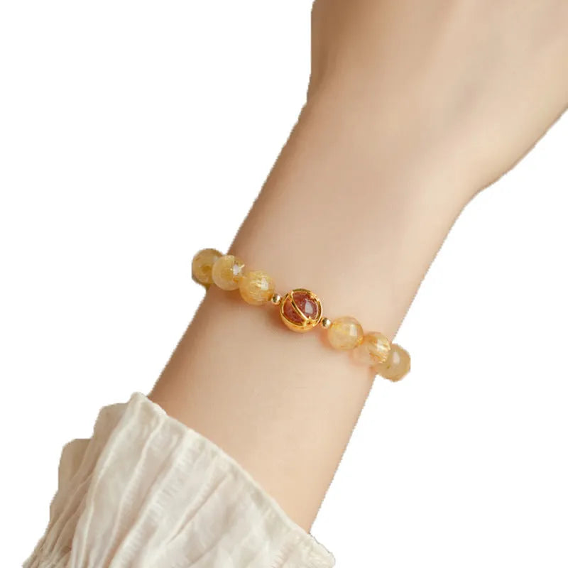 Gold rutilated quartz crystal bracelet with diamond cut stones in unisex Korean style design