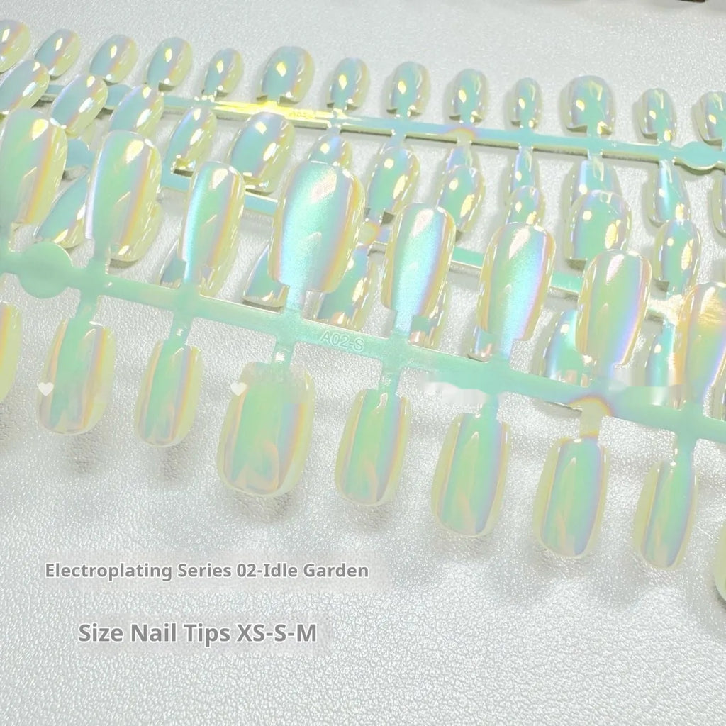Set of electroplated cat's eye artificial nails in short ladder lengths XS, S, and M showing aurora and solid colour styles.