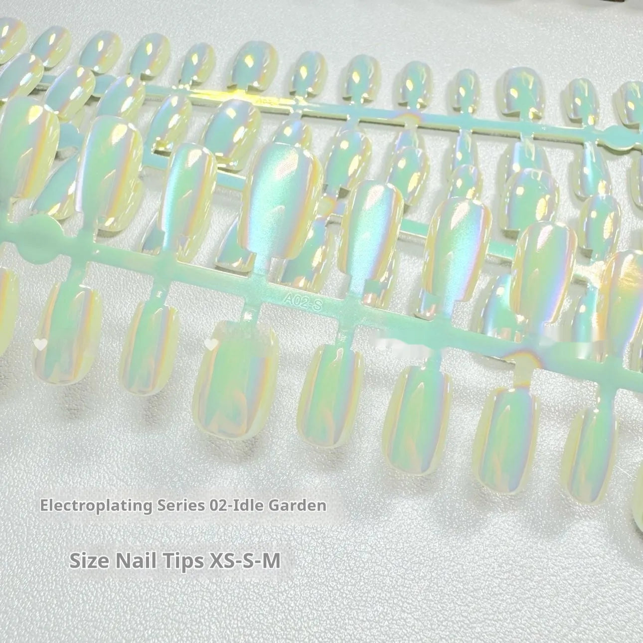 Set of electroplated cat's eye artificial nails in short ladder lengths XS, S, and M showing aurora and solid colour styles.