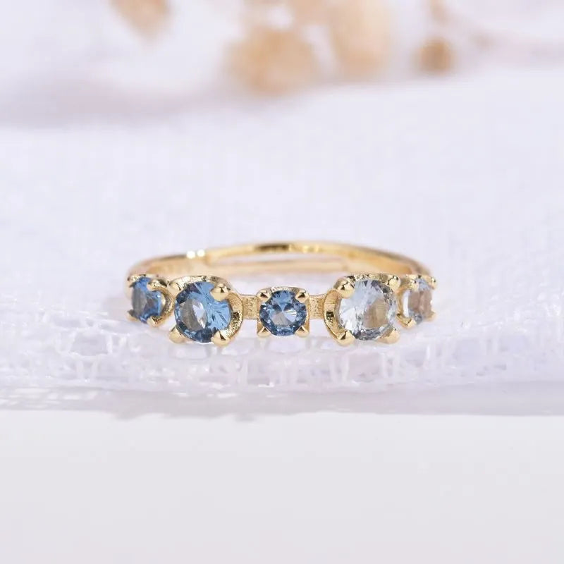 Gradient blue and white topaz multi-gemstone zircon ring with adjustable open mouth design