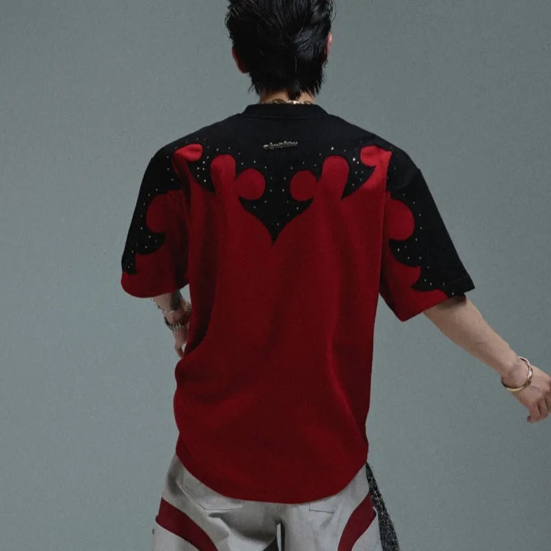 Men's grey cotton T-shirt with burnt flower stitching and rhinestone details on the front, showing loose fit and drop-shoulder sleeves.