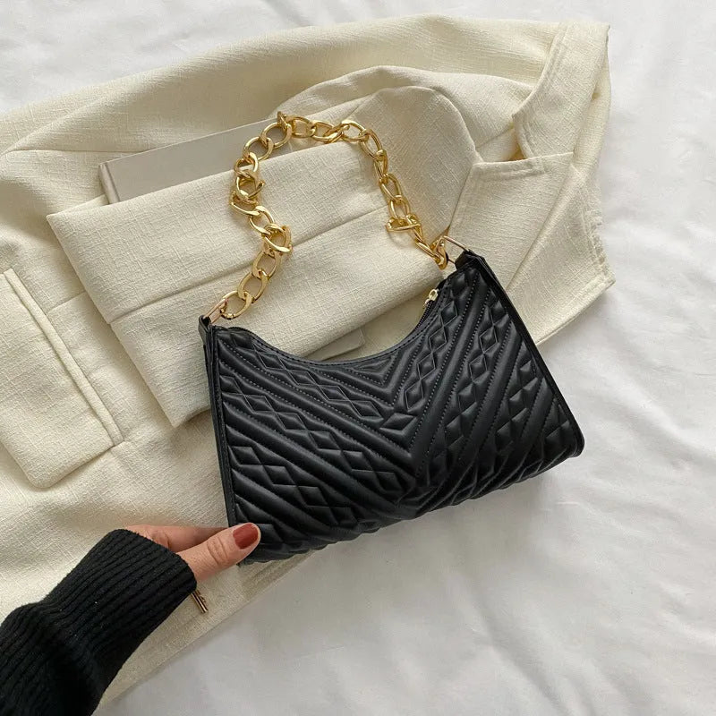 A women's black pleated chain baguette shoulder bag with a vertical square shape and an adjustable strap.