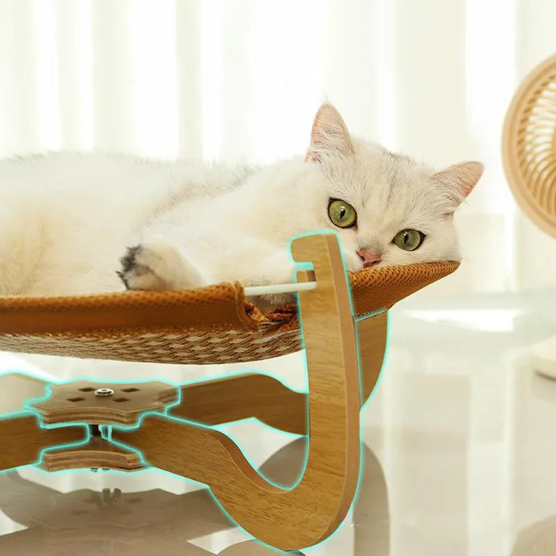 Brown woven rattan raised cot bed for cats and small dogs on a wooden floor