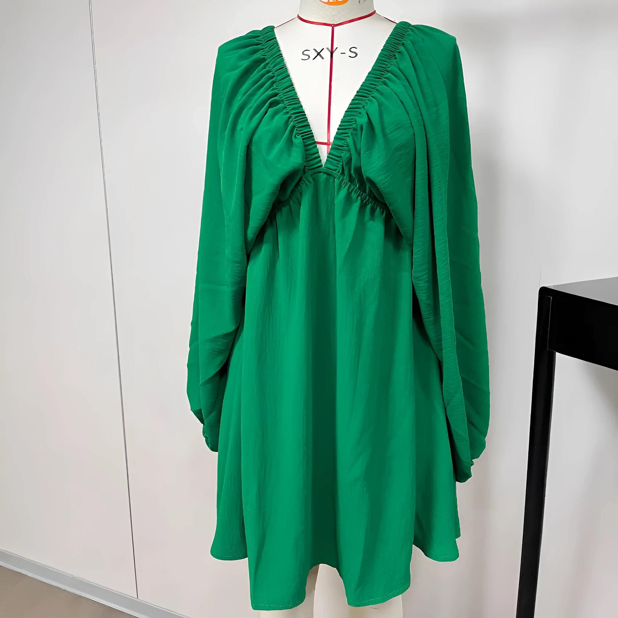 Women's apricot V-neck dress with long puff sleeves and a flounced swing skirt, mid-waist fit.