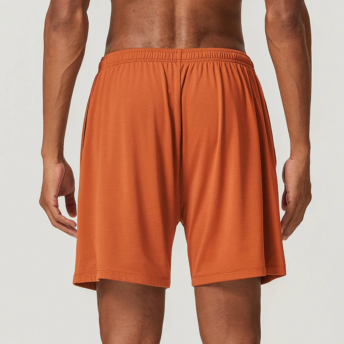 Man wearing sky green quick-drying double-layer running shorts for exercise.
