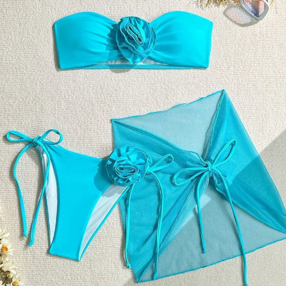 Women's pink bikini set with large 3D flower tie on tube top, matching skirt and pants.