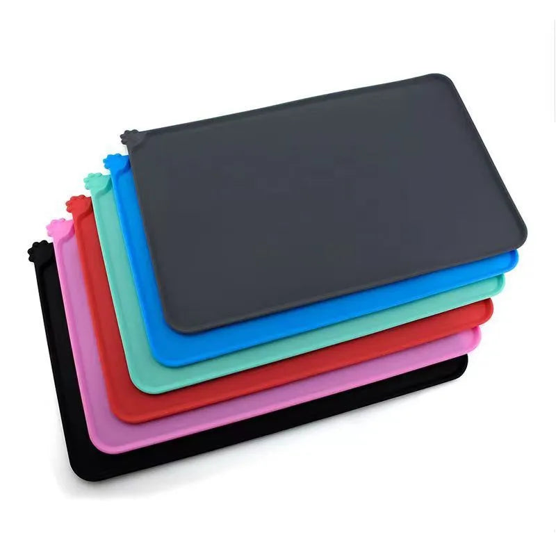 Silicone pet placemat in five colour options beneath dog food and water bowls