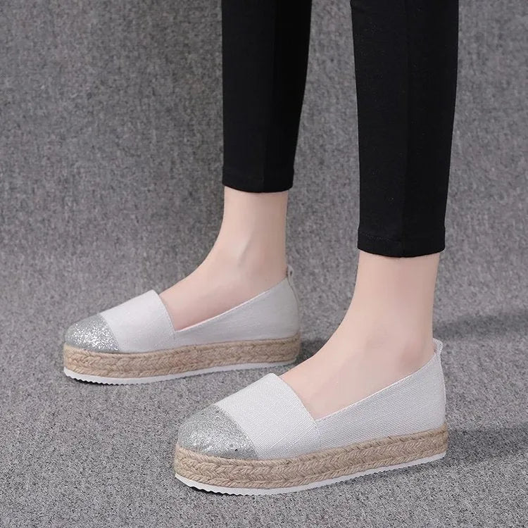 Plus size beige and black breathable canvas flat shoes with round toe and slip-on design.