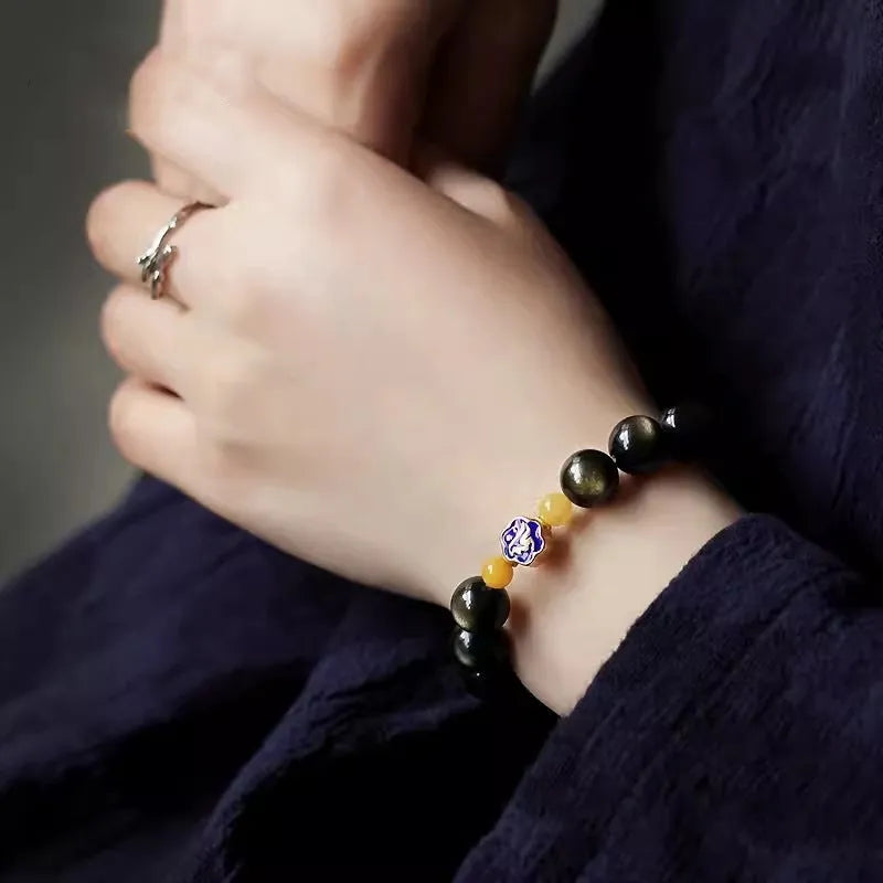 Natural golden obsidian bracelet with geometric zodiac charm bead showing chicken zodiac design