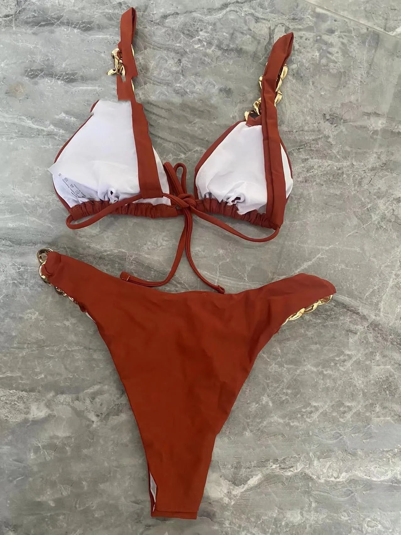Brown women's tube-top push up bikini swimsuit with split bottom on a mannequin.