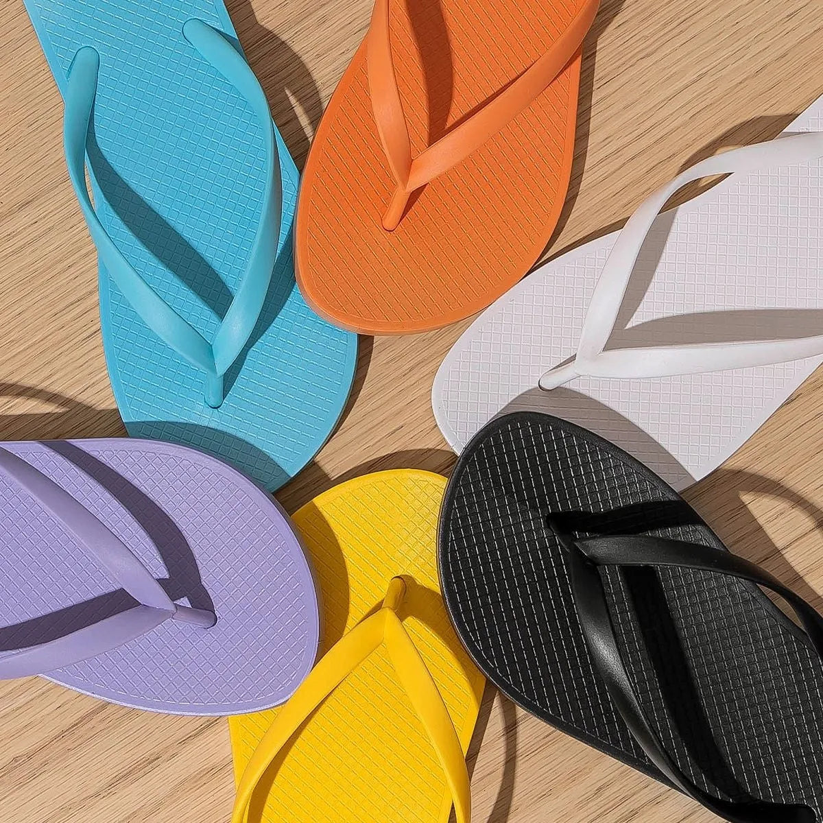 Foldable beach slippers with non-slip PVC soles in orange, purple, black, and white colour options