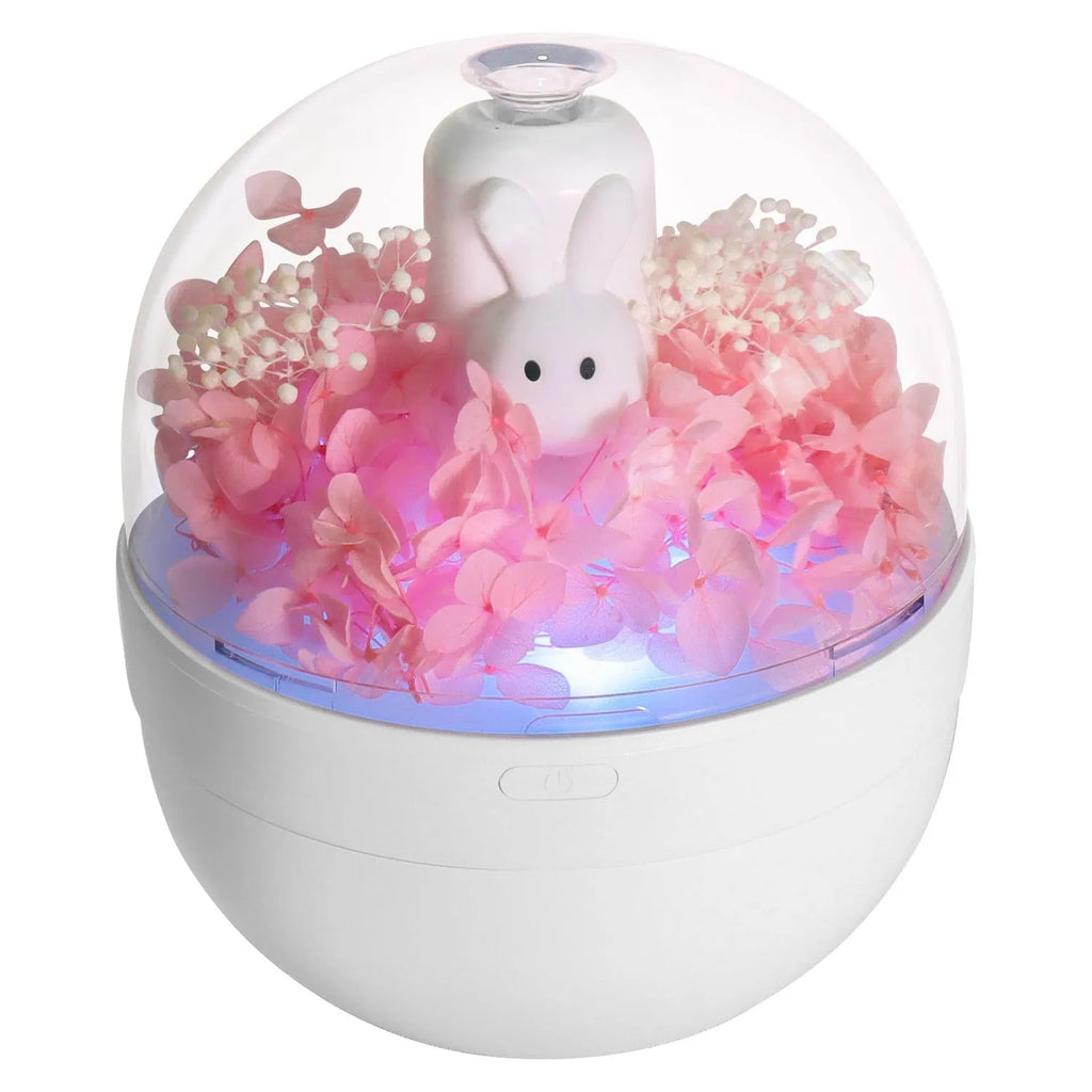 Pink Creative Rabbit aromatherapy humidifier with preserved flowers on top.