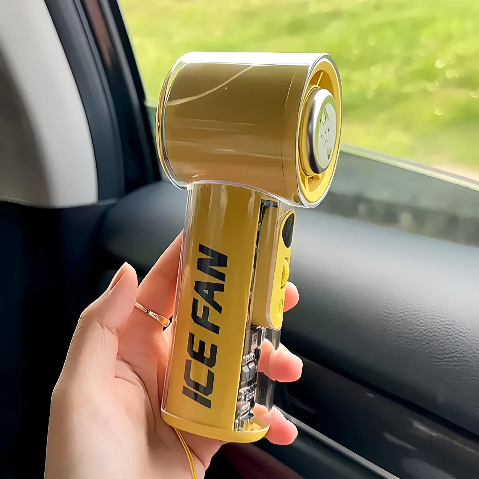Small yellow handheld portable fan with refrigeration ice compress function showing compact design