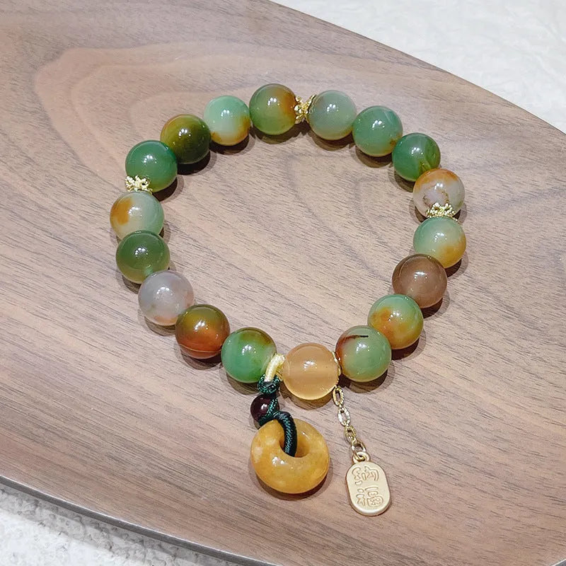Yellow gold tone peacock agate and old mine topaz bracelet with peace buckle closure