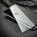 Tempered glass screen protector with 9H hardness for smartphones on a clean surface.