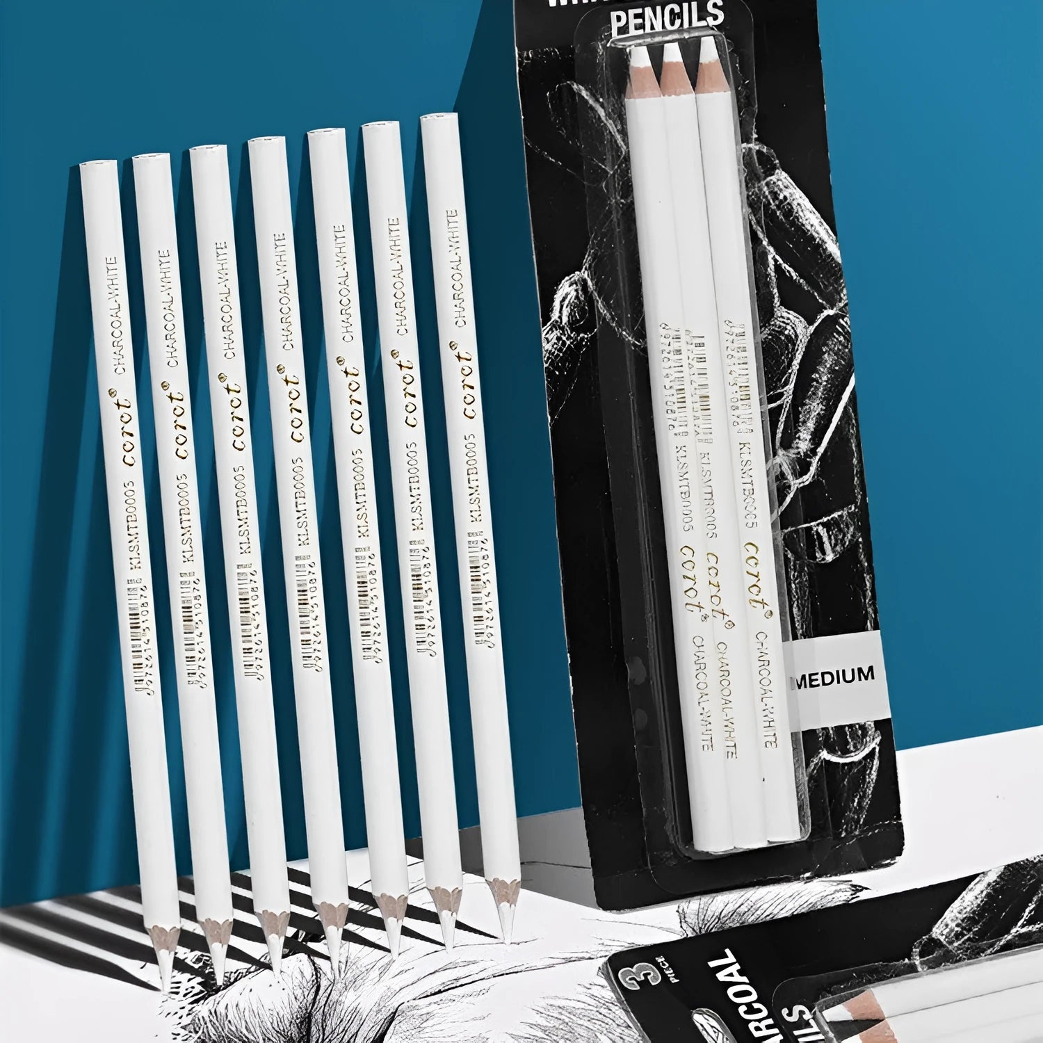 Three white charcoal pencils in wooden barrels for sketching and highlighting on dark papers