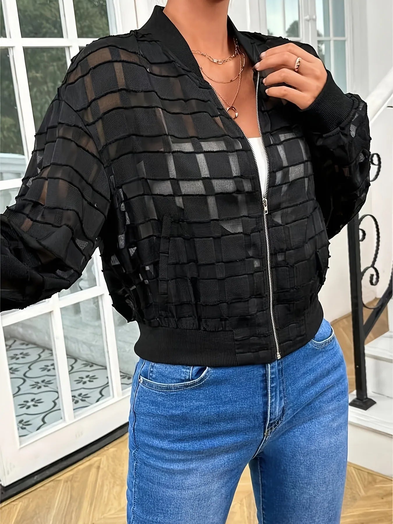 Women's black semi-transparent geometric pattern jacket with front zipper and long sleeves