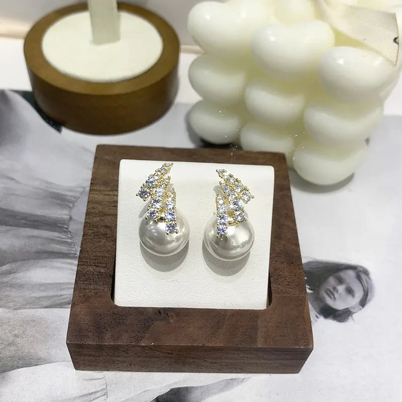 Curved zircon pearl earrings available in golden cats eye stone, golden white pearl, and silver white pearl