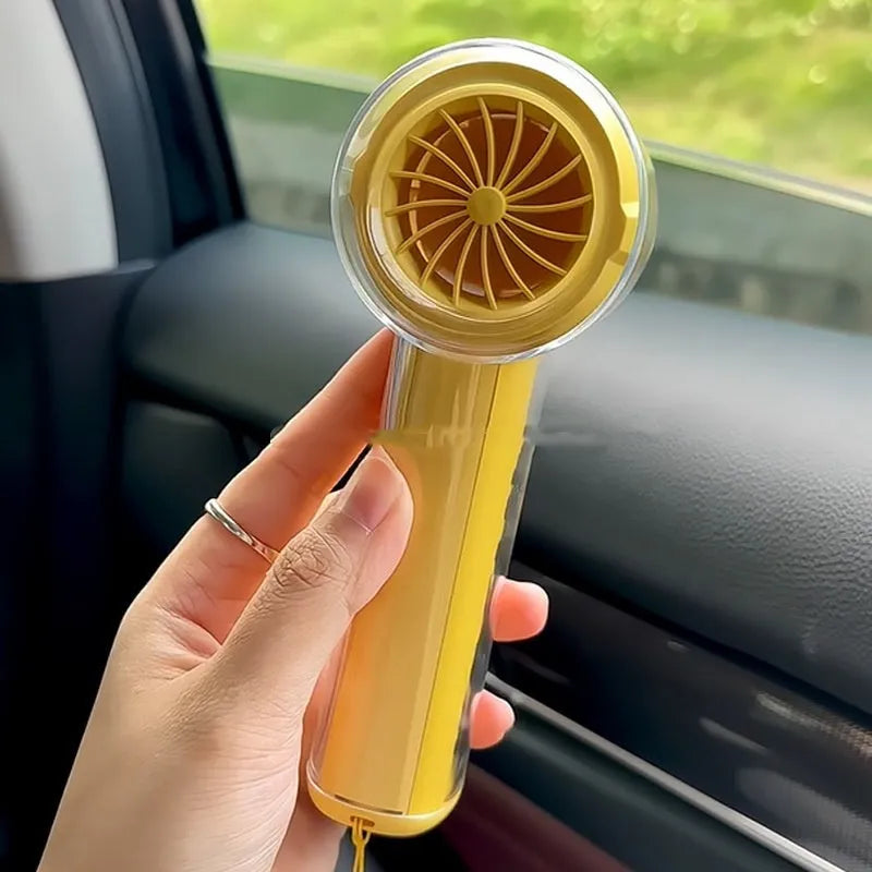 Small yellow handheld portable fan with refrigeration ice compress function showing compact design