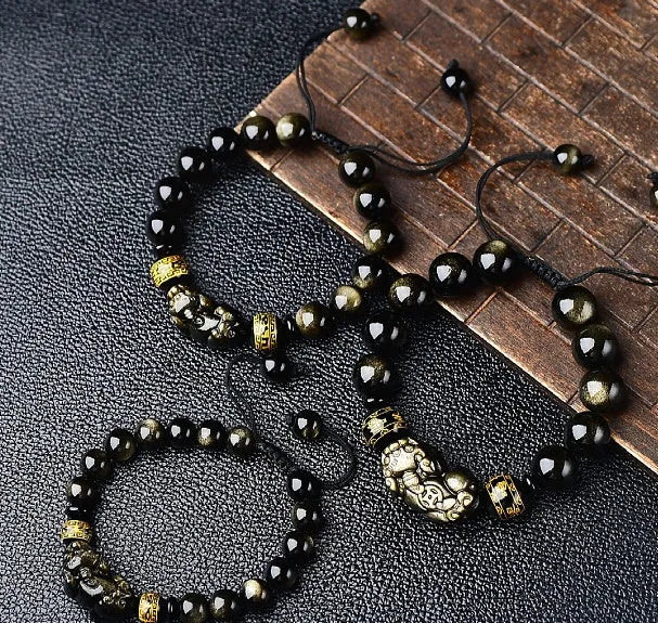 Original hand-woven golden obsidian Pi Xiu bracelet showing bead detail and Chinese style design