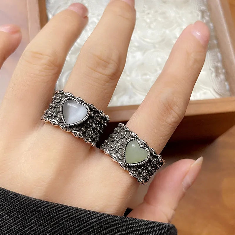Retro wide-faced silver heart ring with adjustable opening on a white background.