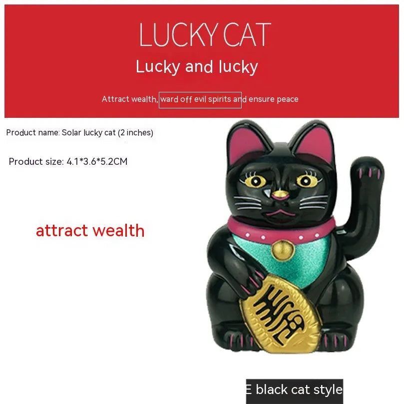 Small yellow solar-powered Maneki Neko lucky cat decoration waving, shown on a car dashboard.