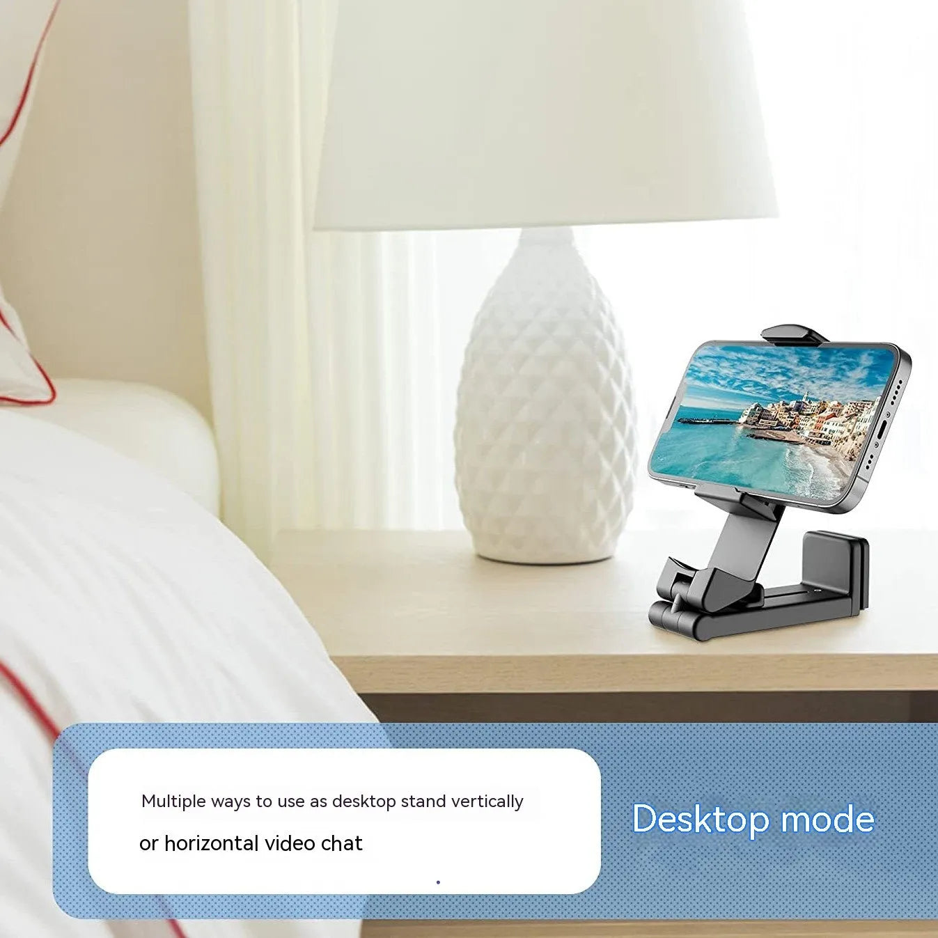 Universal foldable rotating phone holder in black, grey, or green colour on a flat surface, showing its adjustable arm.