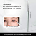 Close-up of a fine-tipped synthetic makeup brush for eyeliner and under-eye concealer application.