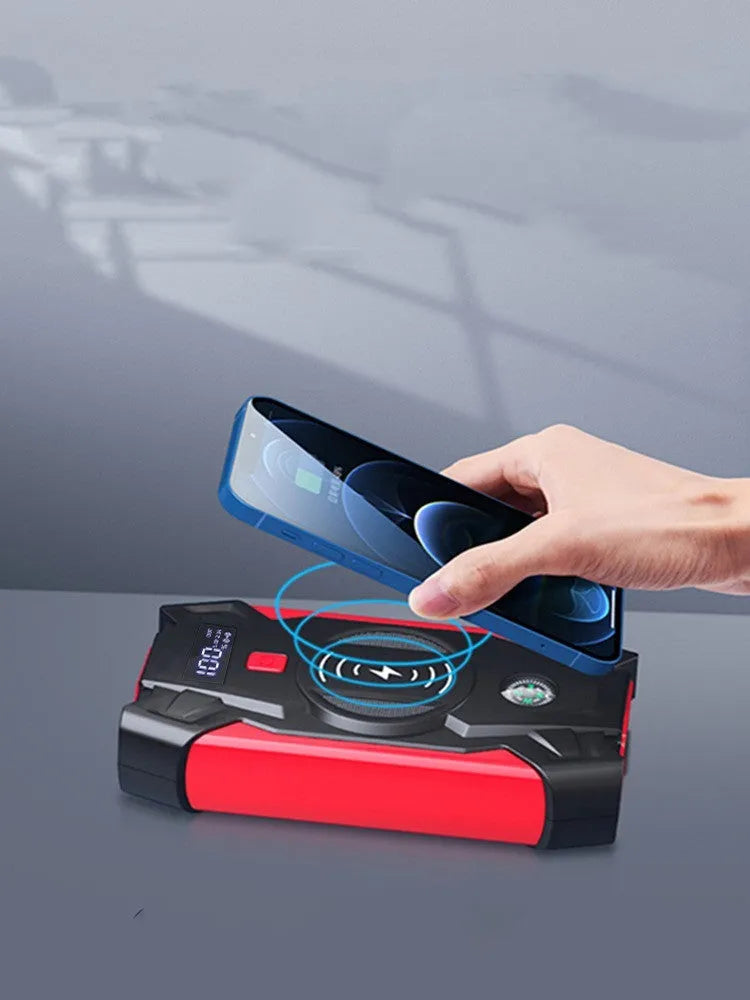 Red portable car battery jump starter power bank with digital display and jumper cables