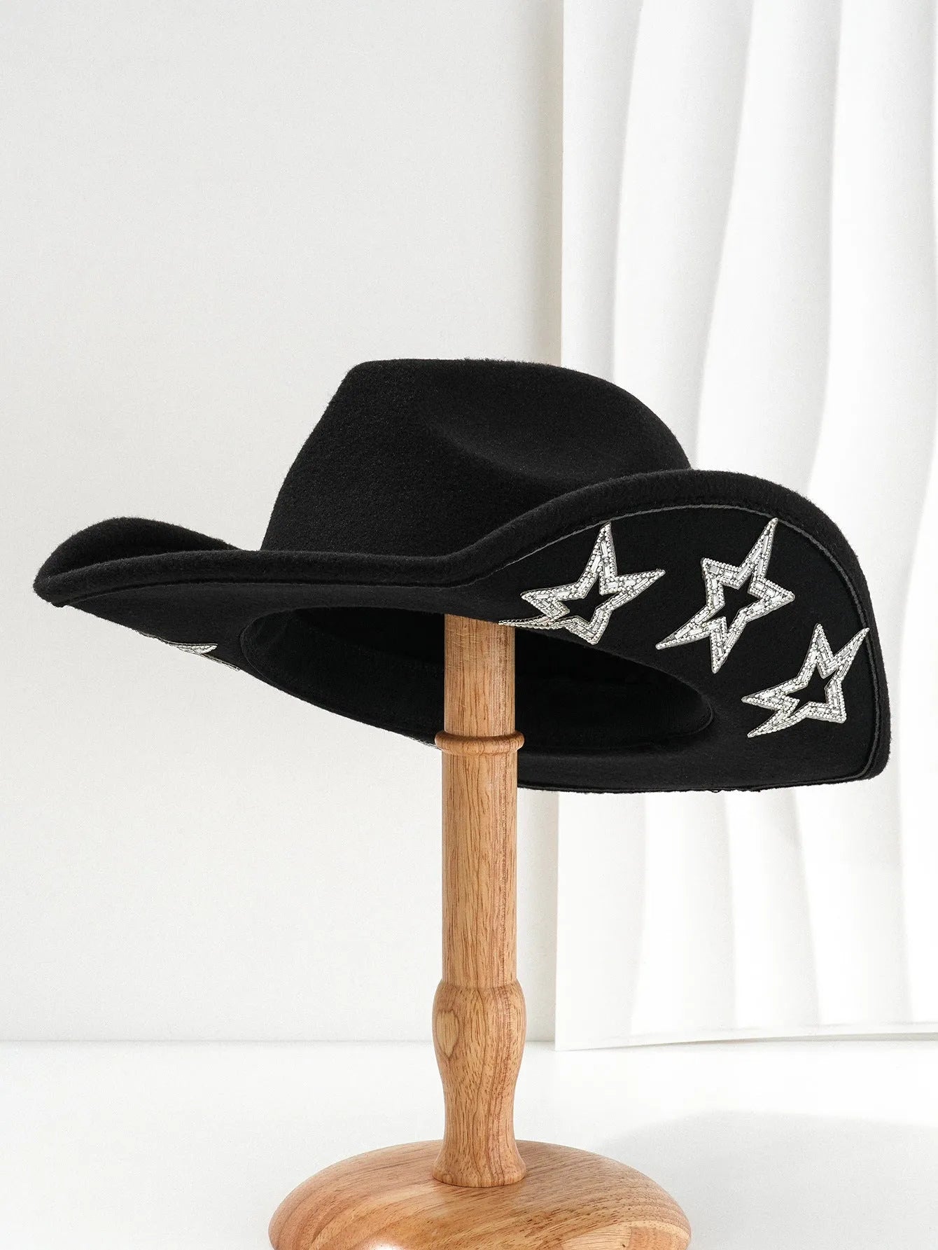 Beige polyester felt western-style top hat with a conical crown and a hexagonal star decoration on the front.