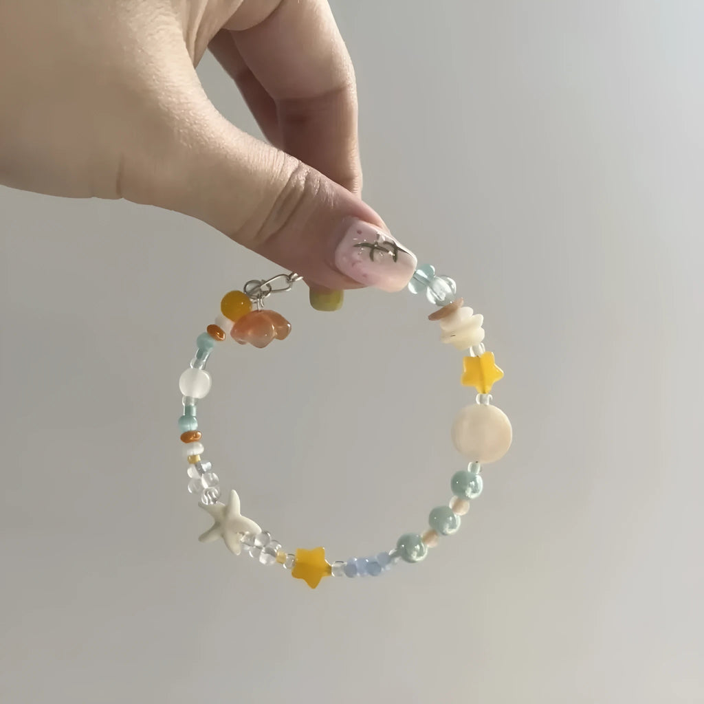 Orange gold-tone bracelet with water-soaked texture, diamond shape and round decorative elements