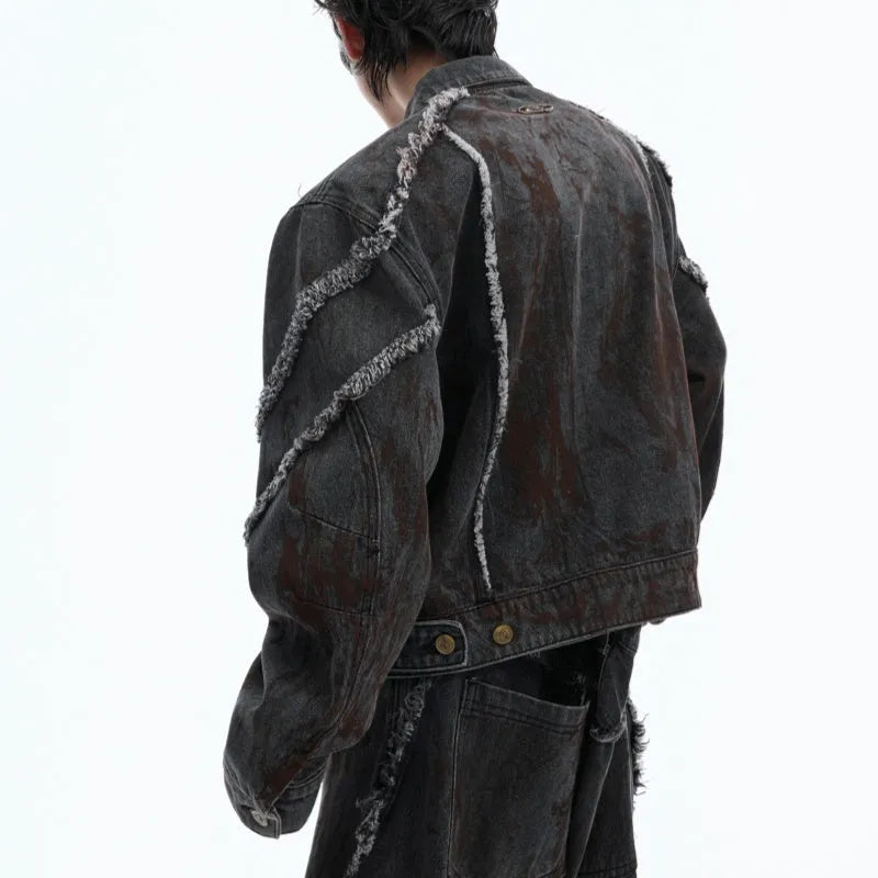 Black gradient distressed denim coat with padded shoulders and matching trousers on a hanger.
