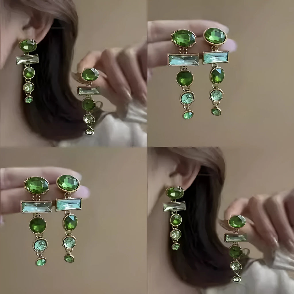 A pair of retro green gradient alloy earrings with geometric Chinese-style design, inlaid zircon stones, and decorative tassels.