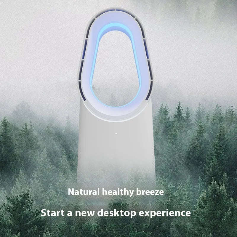 White bladeless tower fan with remote control placed on a desk next to a laptop.