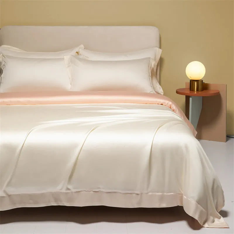 A modern Lenzing Tencel bedding set with a quilt cover and pillowcases in a neutral colour, laid flat on a bed.
