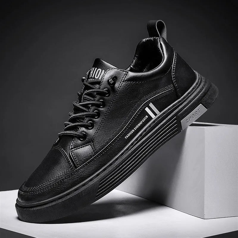Men's low-top skate shoes in black with a round toe, elastic band, and rubber sole.