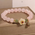 Crystal bracelet with Hetian jade beads, peach blossom charms, and camellia elements in pastoral design