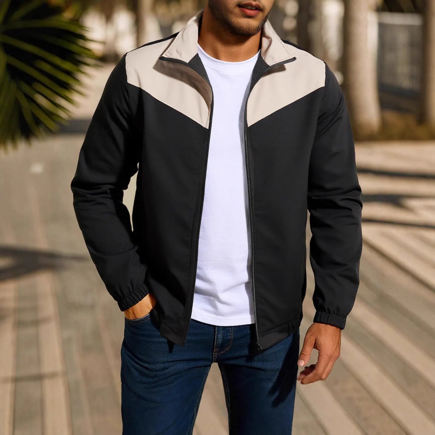 Man wearing a khaki windproof jacket with a high collar and colour-matched front zipper.