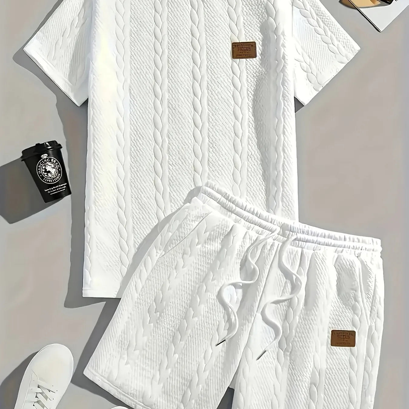 Men's black two-piece sports set with short sleeve T-shirt and matching shorts featuring patch design