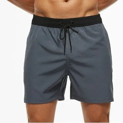 Men's blue running shorts with drawstring waist, stitching detail, and a headband pocket.