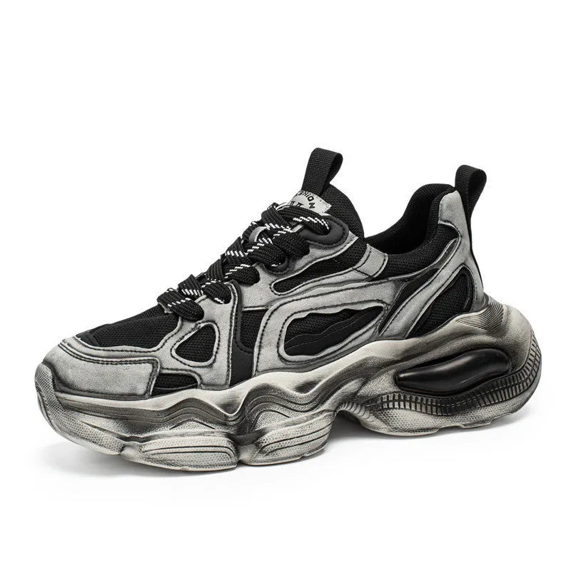 Men's black mesh sneakers with a lace-up front, platform sole, and cross strap detail on a white background