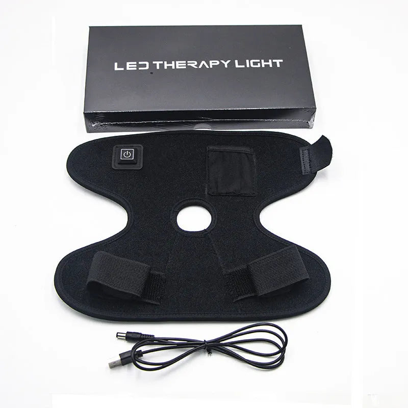 Black adjustable ankle support with red light and heating, USB cable attached