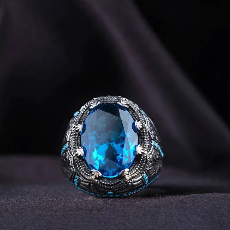 Geometric antique silver alloy couple ring with a blue zircon stone in a Grandmother Diamond setting.