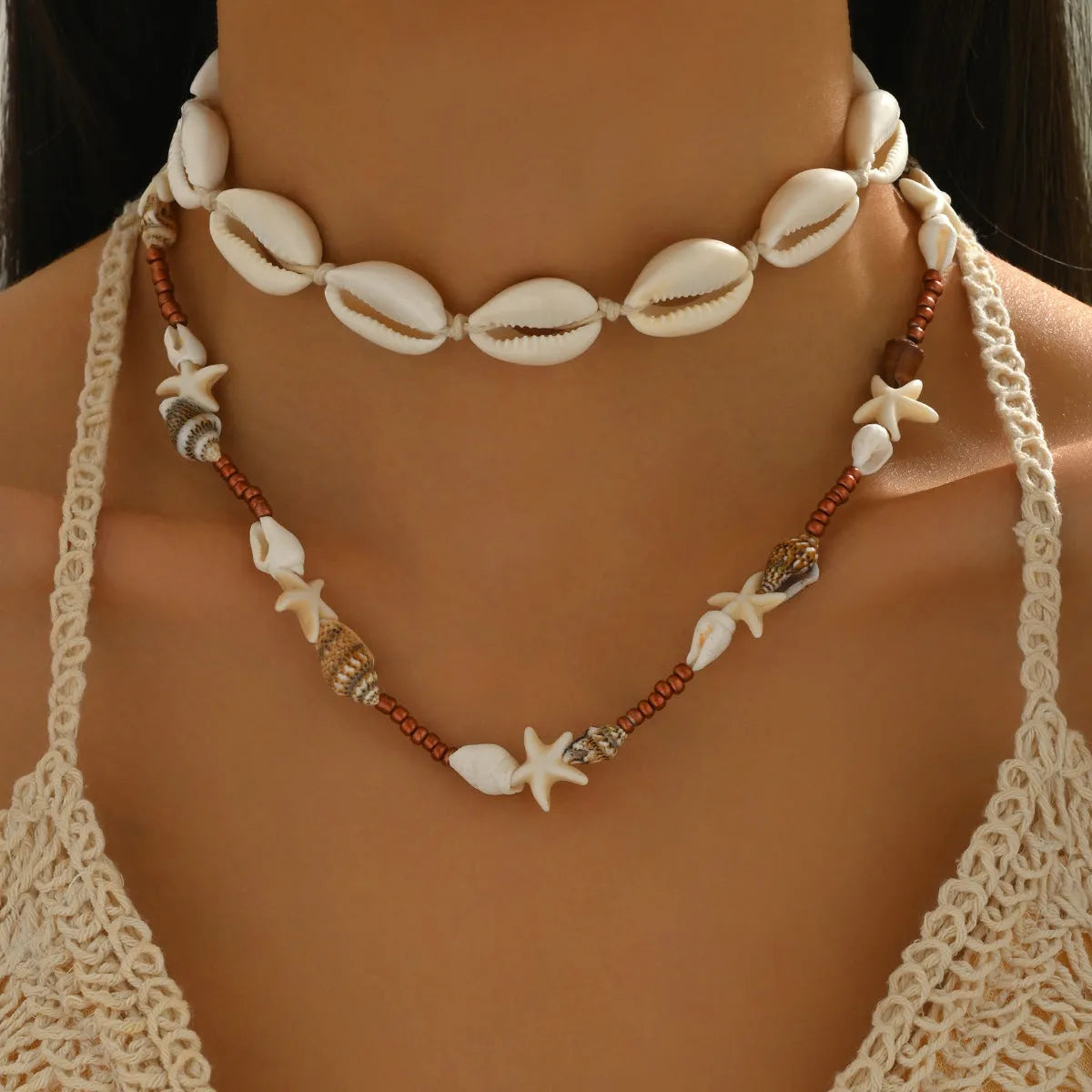 Handcrafted bohemian shell necklace with geometric pendant on a regular chain, colour X1900.