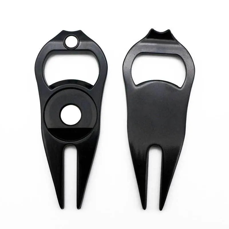 Black zinc alloy golf ball yoke bottle opener tool on a putting green.
