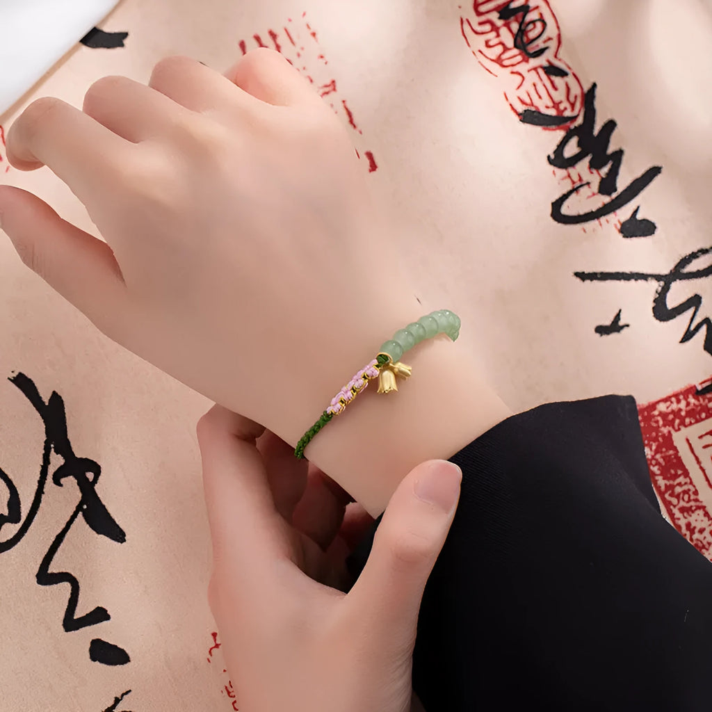 Red rope hand woven women's bracelet with floral decorative elements in BZ479 colour